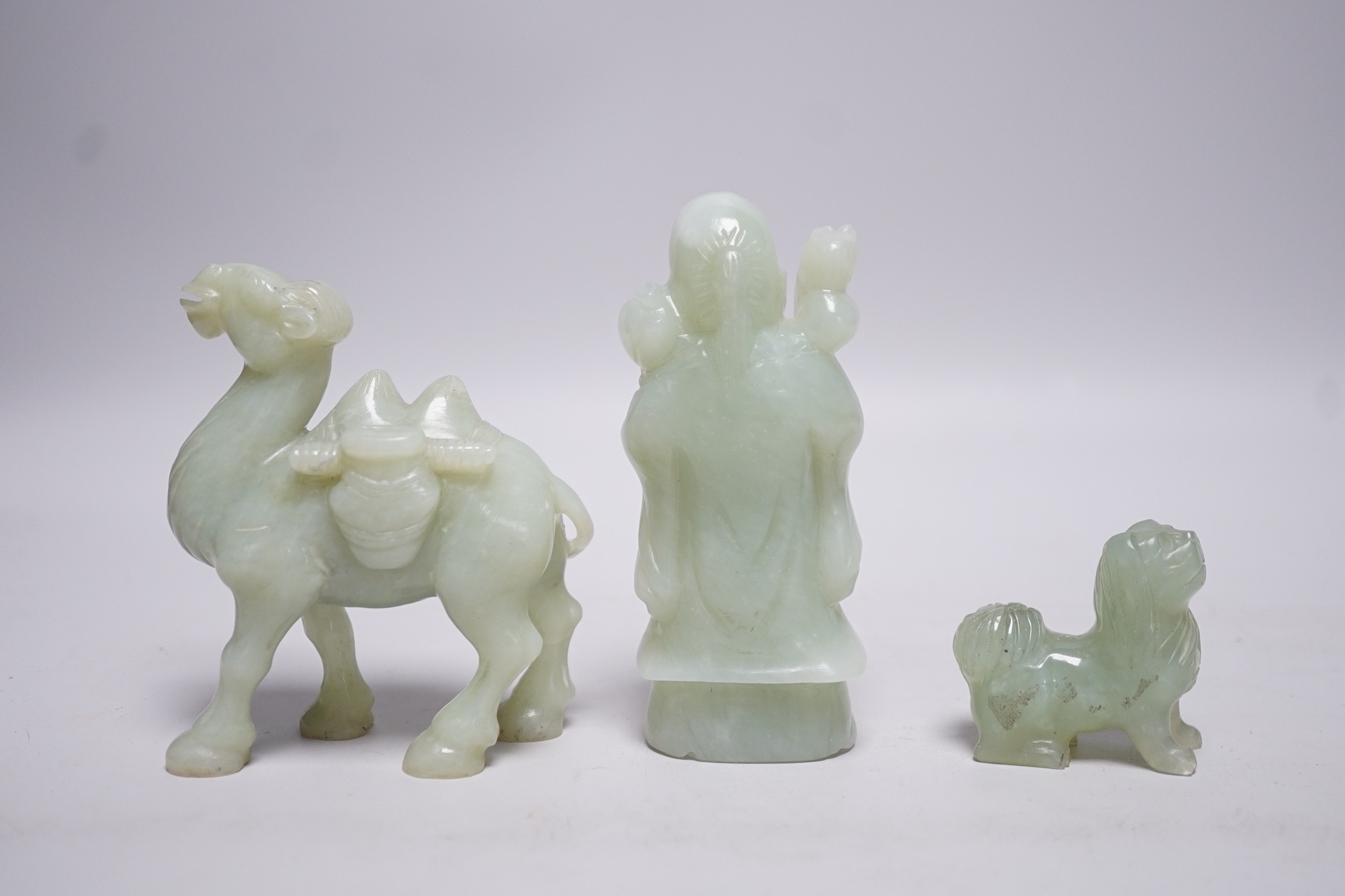 Three Chinese bowenite jade carvings of a Bactrian camel, a Pekinese dog and Shou Lao, tallest 12cm